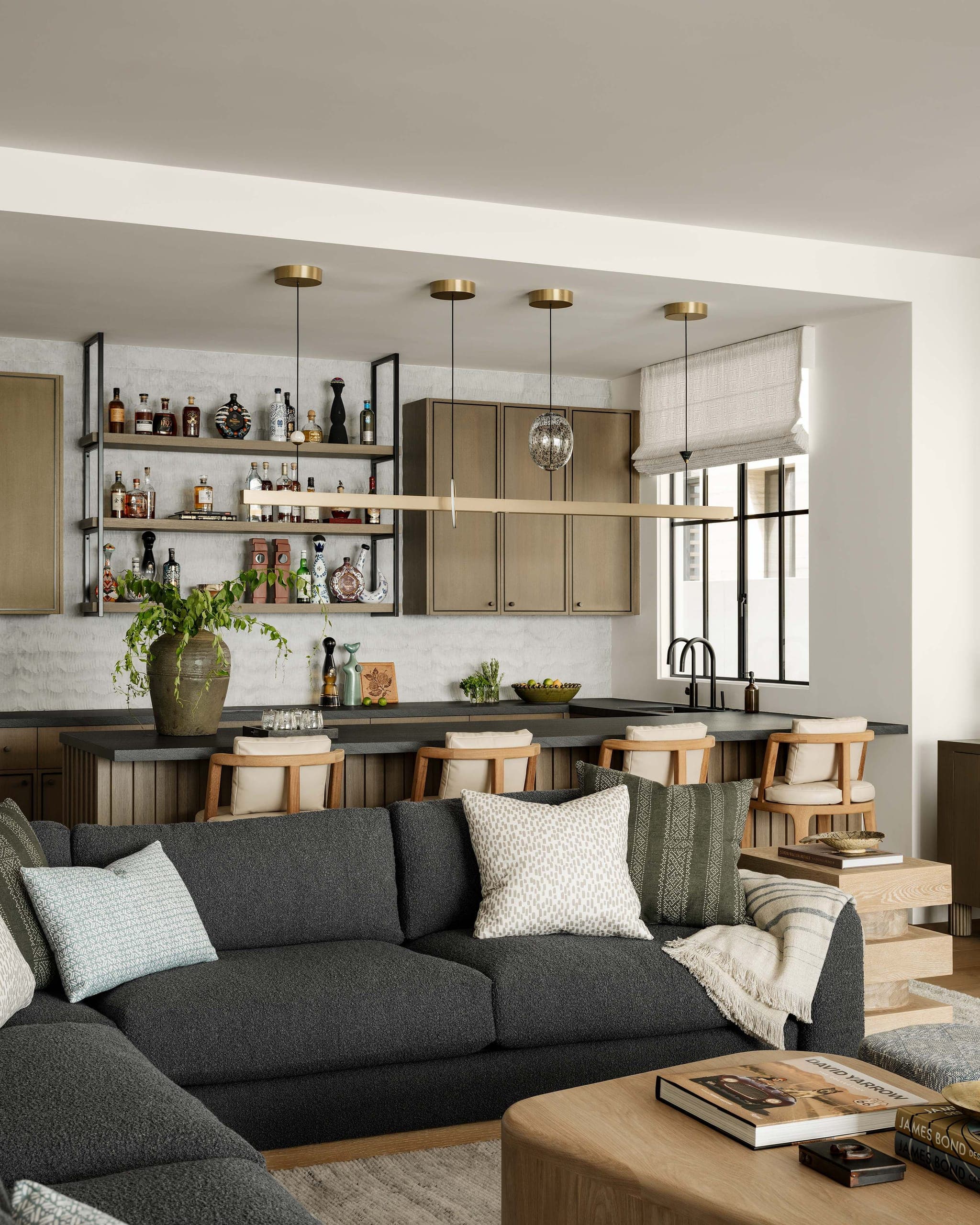 A living space with warm natural oak shelving and wood over oak floors in soft daylight.