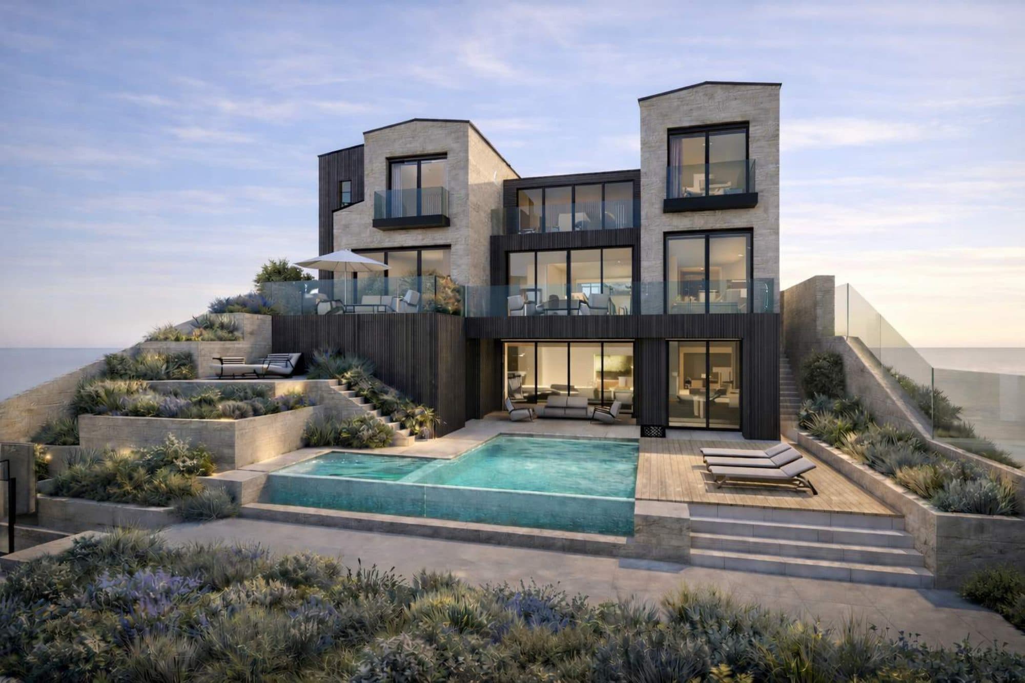 A rendering of Strand Beach III, a stone and dark-glass home at The Strand in Dana Point with terraced gardens and an infinity pool facing the ocean.